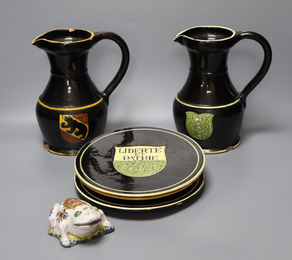 A part-set of 19th century Swiss glazed terracotta items, signed, Desa Steffisburg, each with sgraffito crest, jugs 20cm, and a Rouen s